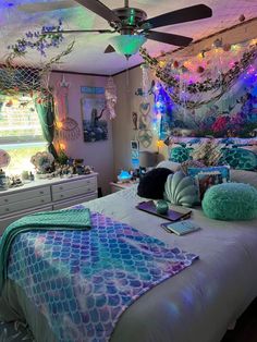 a bedroom with mermaid decor and lights on the ceiling