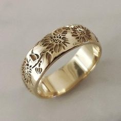 Sunflower ring, elegant and unique 14k gold wedding ring, unique gold wedding ring for the stylish bride to be.* Band width: 6 mm* Thickness: 1.2 mm* Available in 14K or 18K YELLOW, WHITE and ROSE gold.   The price listed is for 14K please contact me for 18K pricing.* Sizes vary from 5 US to 8 US, including half sizes.    Please choose your size upon checkout.* Please choose a finish: Shiny or Matte, and mention in note to seller.* This item is handmade, please allow 2-4 weeks of processing befo Sunflower Wedding Rings, Unique Gold Wedding Rings, Posey Ring, Floral Wedding Ring, 14k Gold Wedding Ring, Wedding Ring Unique, Stylish Bride, Engraved Wedding Rings, Gold Flower Ring