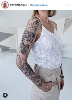 a woman with tattoos on her arm posing for the camera