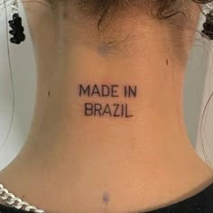 a woman's neck with the words made in brazil written on her left side