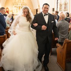 the bride and groom are walking down the aisle at the wedding ceremony in their church