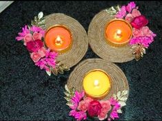 three plates with candles and flowers on them