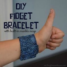 a close up of a person's arm with a bracelet on it and the text diy fidget bracelet