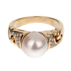 The Vintage Bvlgari Pearl Diamond Yellow Gold Ring is an exquisite piece of jewelry that exemplifies the luxurious craftsmanship and timeless elegance for which the Bvlgari brand is renowned. This stunning ring features a magnificent 9mm pearl as its centerpiece, radiating a soft and enchanting luster that captivates the eye. The pearl is flawlessly round, with a smooth and reflective surface that displays subtle hues of white and cream, adding to its mesmerizing beauty. Crafted from 18k yellow gold, the band of the ring is designed with a sophisticated and elegant aesthetic. The rich, warm tones of the yellow gold complement the pearl perfectly, creating a harmonious balance between the two elements. The band is meticulously polished to a high shine, enhancing its opulent appearance and m Luxury White Gold Dome Ring For Formal Occasions, Luxury Formal White Gold Dome Ring, Luxury Brilliant Cut Pearl Ring For Formal Occasions, Luxury Pearl Ring With Brilliant Cut For Formal Occasions, Luxury Formal Rings With Pave Setting, Formal Brilliant Cut Pearl Ring, Elegant Dome Ring With Pave Setting For Formal Occasions, Luxury Dome Ring With Center Stone For Formal Events, Luxury Formal Dome Ring With Center Stone