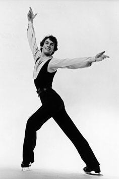 a man in black and white doing a dance pose