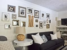 a living room filled with furniture and pictures on the wall