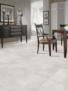 a dining room with white tile flooring and furniture