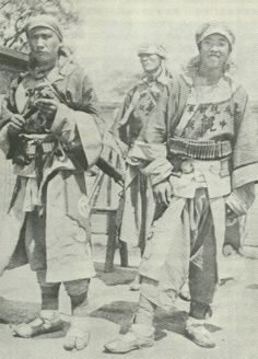 an old black and white photo of three men in native garb standing next to each other