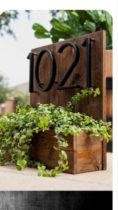 a wooden block with plants growing out of it and the number twenty two on top