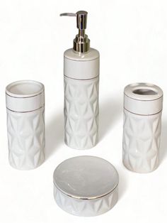 a white bathroom set with soap dispenser and toothbrush holder