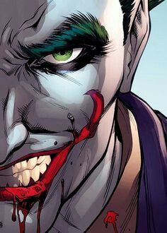 the joker with green hair and red eyes is looking at something in his mouth,