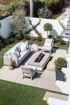 an outdoor living area with couches, chairs and tables in the middle of it