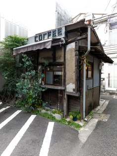 an old run down building sitting on the side of a road