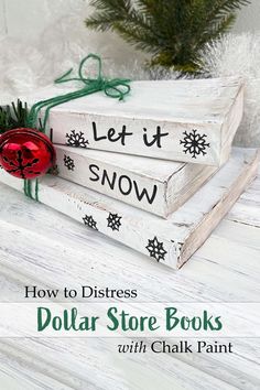 three wooden books stacked on top of each other with the words let it snow written on them