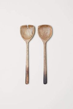 two wooden spoons sitting next to each other