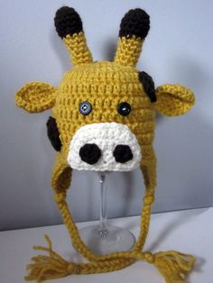 a crocheted giraffe hat is on display