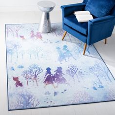 a blue chair sitting on top of a white floor next to a rug covered in trees