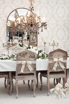 a dining room table with chairs and a chandelier