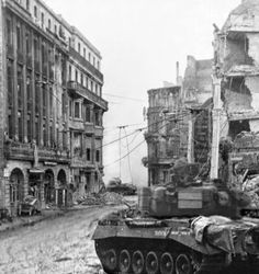 an old black and white photo of a tank in the middle of a destroyed city