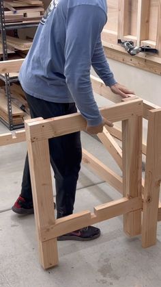 a man is working on some wooden furniture