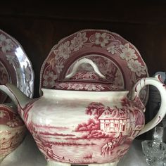 a red and white china set on top of a table