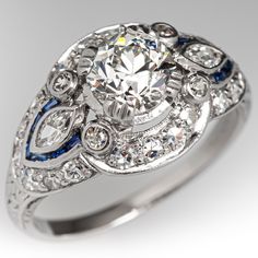 an antique style diamond and blue sapphire engagement ring