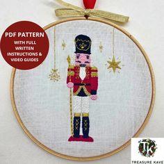 a cross stitch pattern for a nutcracker ornament with the text, pf pattern which includes instructions and video guides