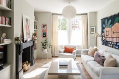 a living room filled with furniture and a fire place