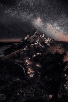 the night sky is filled with stars above a mountain