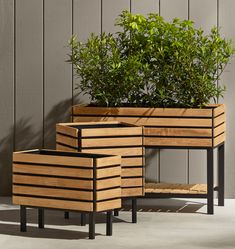 three wooden planters sitting next to each other