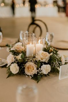 the centerpiece is adorned with candles and flowers for an elegant touch to the table