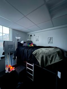 a bed room with a neatly made bed next to a window and a tv on a stand