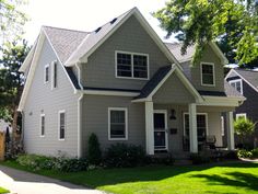 a gray house with white trim and windows