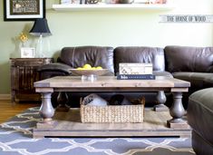 a living room with leather couches and a coffee table in front of the couch