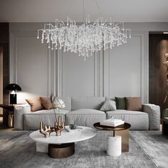 an elegant living room with chandelier, sofa and coffee table in grey tones