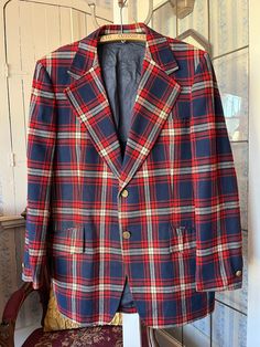 This fantastic jacket from Park Row is made from 55 per cent polyester and 45 per cent wool in white, dark red and navy blue plaid. It has the original buttons in the front and on the cuffs, three outside pockets and two inside pockets, and it's partially lined with dark blue silky lining. The measurements, taken with the coat lying flat, are: shoulder to shoulder, 19 inches; armpit to armpit, 24 inches; sleeves, 27 inches; length, 35 inches; bottom edge, 33 inches. In very good condition. Red Plaid Jacket, Jacket Sport, Mens Sport Coat, Wool Blend Jacket, Vintage Plaid, Plaid Blazer, Plaid Jacket, Red Plaid, Blue Plaid