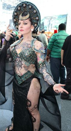 a woman with tattoos on her body wearing a costume