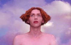 a woman with red hair looking up into the sky