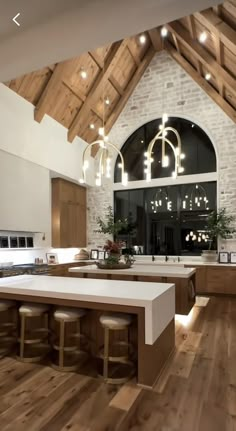 a large kitchen with wooden floors and white counter tops