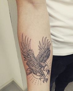 an eagle tattoo on the left arm