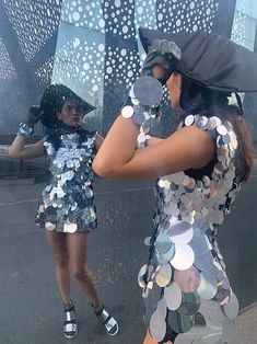 two women are dressed in sequins and hats