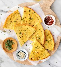 tortilla slices on a plate with sauces and condiments next to it