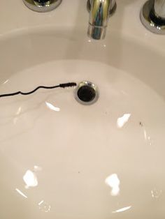 an electric toothbrush is plugged into the sink