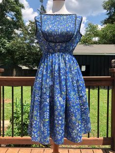 "Such a pretty blue floral dress! I love the accordion bib outlined in black rickrack trim. This dress can be transitioned from spring-autumn in my opinion. Just add a cropped cardigan for a more vintage look or a fitted denim jacket for something more hipster! You will most likely need a slip as she is fairly sheer. For the future owner: Please send picture, because I LOVE this one! Excellent vintage condition! Measurements taken flat, please double: Bust 19\" Waist 13\" Length 38\" All sales a Vintage Square Neck Dress For Day Out, Blue Floral Print Dress With Full Skirt, Blue Empire Waist Dress With Floral Print, Blue Floral Print Empire Waist Dress, Fitted Casual Vintage Dress For Spring, Casual Fitted Vintage Dress For Spring, Vintage A-line Dress For Spring Dress Down, Spring Vintage A-line Dress For Casual Occasions, Spring A-line Vintage Dress For Dress Down Occasions