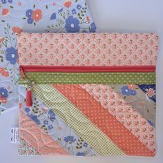 four pieces of fabric with different patterns and colors on them, all lined up together