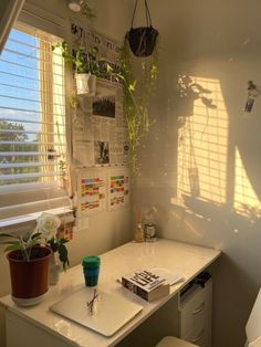 a desk and chair in a small room with sunlight coming through the window onto the wall