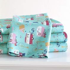 the bedding is neatly made and ready to be used in the bedroom or playroom