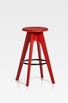 a red stool sitting on top of a white floor