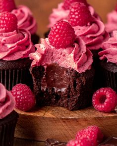 chocolate cupcakes with raspberry frosting and fresh raspberries