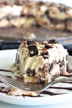 a piece of ice cream cake on a plate with a fork in front of it